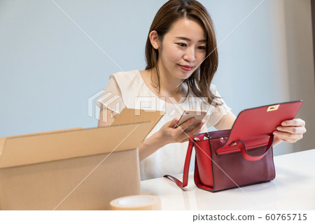 A woman shooting a bag 60765715