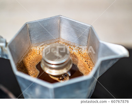 Making black moka coffee using moka coffee maker close-up Making black moka coffee using moka coffee maker close-up 60767876