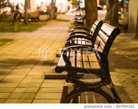benches on pavement in light lantern at night benches on pavement in light lantern at night 60769101