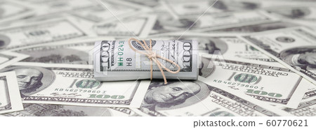 US dollars rolled up and tightened with band lies US dollars rolled up and tightened with band lies 60770621