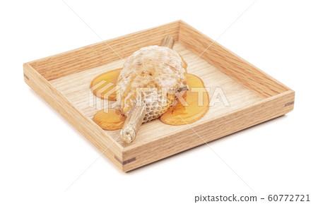 honeycomb on wooden plate for food ingredients isolated on white background honeycomb on wooden plate for food ingredients isolated on white background 60772721