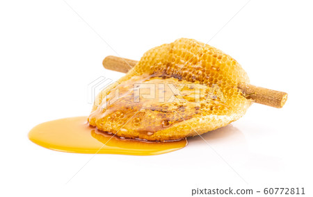 Honeycomb with sweet honey on dry branch isolated on white background 60772811