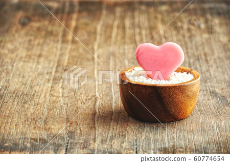 Pink heart shaped seeds grow on the flowerpot with wood table background ,love concept. Pink heart shaped seeds grow on the flowerpot with wood table background ,love concept. 60774654