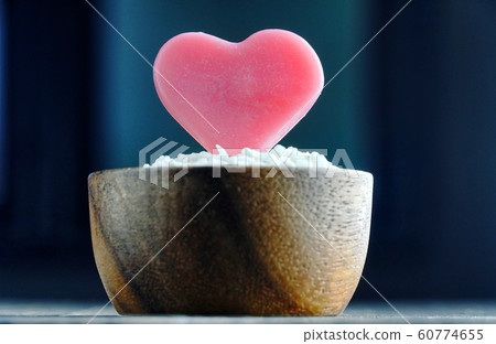 Close up pink heart shaped seeds grow on the flowerpot with wood table background ,vintage love concept. Close up pink heart shaped seeds grow on the flowerpot with wood table background ,vintage love concept. 60774655