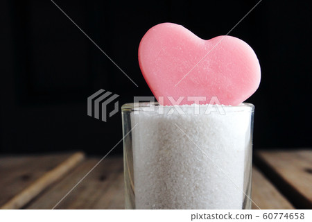 Pink heart shape on small pot glass on wood table background ,vintage love concept. 60774658