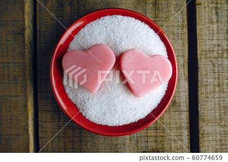 Topview two pink heart shape on red pot on wood table background ,vintage love concept 60774659
