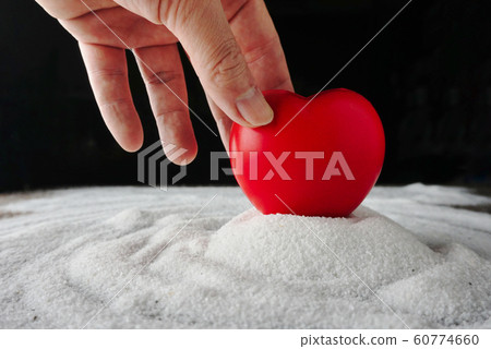 Hand pick up red heart from white sand , love concept . Hand pick up red heart from white sand , love concept . 60774660