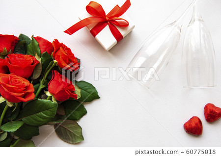 Red roses and glasses Red roses and glasses 60775018
