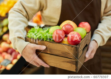 Unrecognizable Man Holding Box of Fresh Fruits and Vegetables Unrecognizable Man Holding Box of Fresh Fruits and Vegetables 60778307