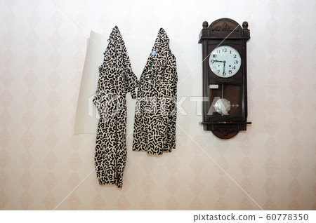 Old clocks and drills hanging on the wall 60778350