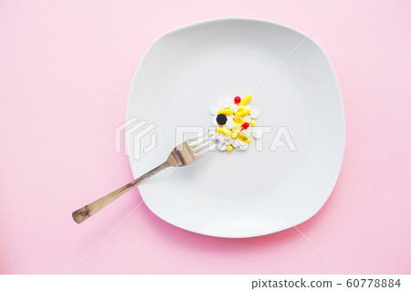 Close up of pills. Dietary supplements. Variety pills. Vitamin capsules on pink background Close up of pills. Dietary supplements. Variety pills. Vitamin capsules on pink background 60778884