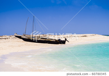 Typical outrigger fishermen pirogues moored on turquoise sea of Nosy Ve island, Indian Ocean, Madagascar Typical outrigger fishermen pirogues moored on turquoise sea of Nosy Ve island, Indian Ocean, Madagascar 60780345