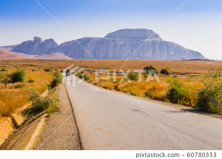 Madagascar, scenic view of Route Nationale 7 (RN7), with Cardinal's hat in background, huge granite mountain forming part of Andringitra massif 60780353