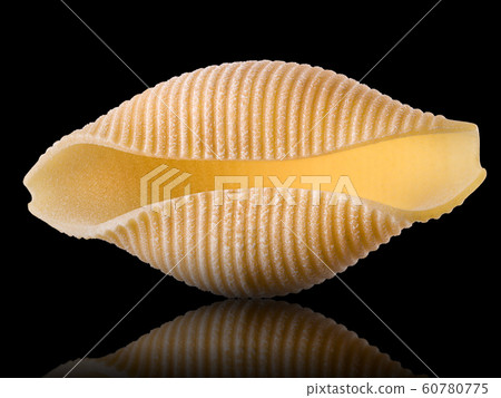 Macro photo of conchiglie pasta shell isolated on black background Macro photo of conchiglie pasta shell isolated on black background 60780775