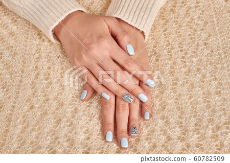 Delicate female hands on the fluffy knit 60782509