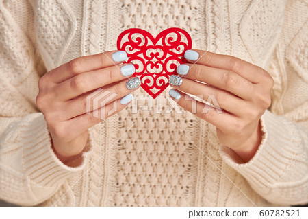 Beautiful openwork heart in female hands. Beautiful openwork heart in female hands. 60782521