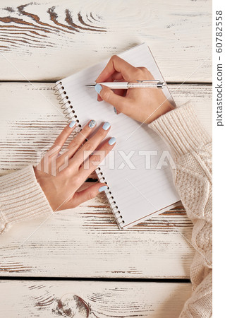 Writing in a notebook with a spiral. Signature on Writing in a notebook with a spiral. Signature on 60782558