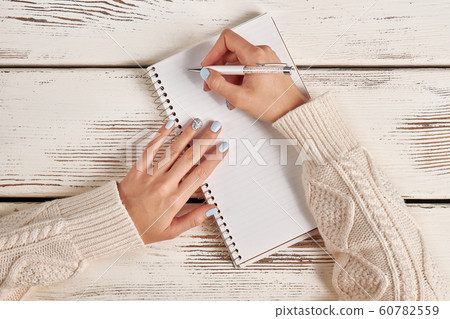 Beautiful female hand with manicure hold a pen. 60782559