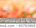 Wooden table in front of abstract blurred orange bokeh light background  60783868