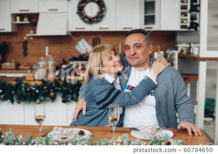 Happy beautiful adult woman hugging her husband 60784650