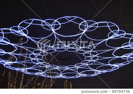 Christmas lights decorating a park to celebrate Christmas holidays 60784736