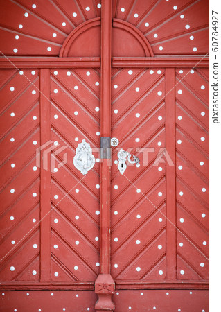 Beautiful old red wooden door in castle 60784927