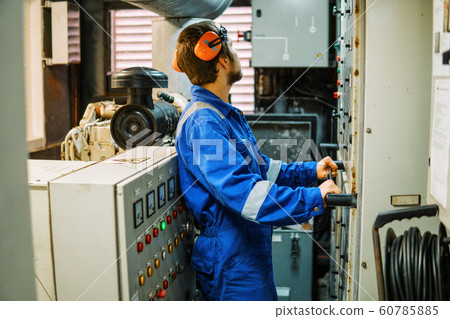 Marine engineer inspecting ship's engine or generators 60785885