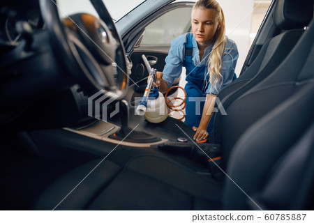 Female washer cleans automobile interior, car wash Female washer cleans automobile interior, car wash 60785887