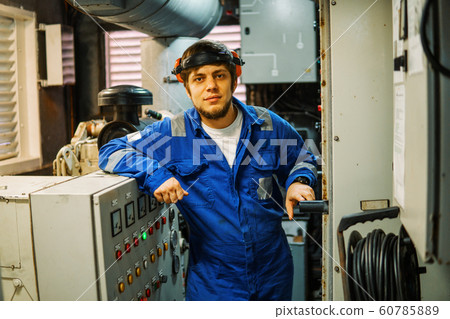 Marine engineer inspecting ship's engine or generators 60785889