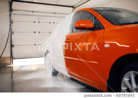 Automobile is half in foam, car wash service Automobile is half in foam, car wash service 60785891