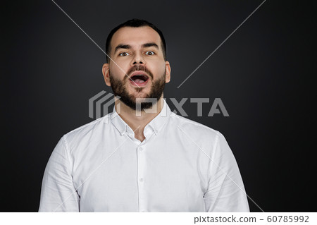 surprised handsome bearded man with shocked facial expression 60785992