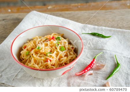 A cup of instant noodles placed on a wooden table A cup of instant noodles placed on a wooden table 60789470