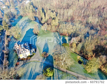 Aerial view of big villas with garden surrounded by forest during winter season 60791782