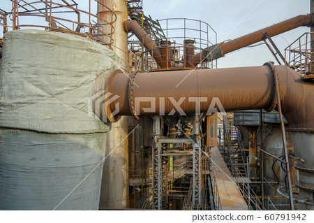 ndustrial plant with old rusty pipes and cooling tower 60791942