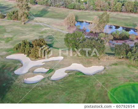 Aerial view over golf field Aerial view over golf field 60792654