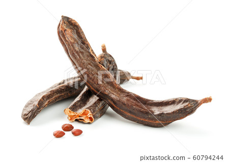 Carob carob fruit and seeds on white background. Carob carob fruit and seeds on white background. 60794244