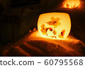 Candle light in ice and snow on Christmas day 60795568