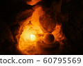 Candle light in ice and snow on Christmas day 60795569