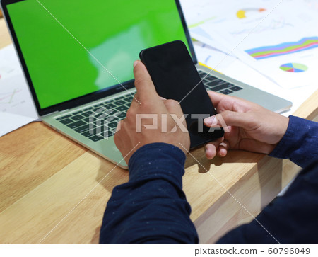 Mock up of a business man holding smartphone Mock up of a business man holding smartphone 60796049