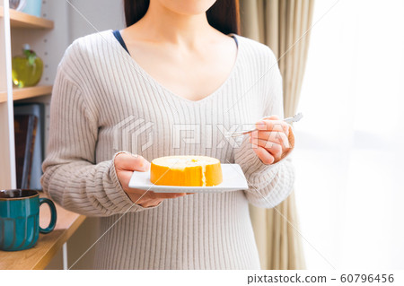 Woman eating sweets roll cake Woman eating sweets roll cake 60796456