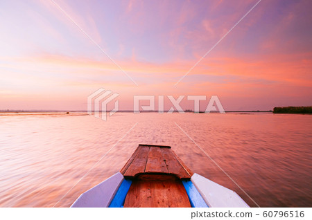 Thai wooden boat bow travel in peaceful blue Nong Harn Lake - Udon Thani, Thailand Thai wooden boat bow travel in peaceful blue Nong Harn Lake - Udon Thani, Thailand 60796516