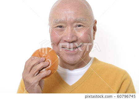 Senior eating anpan with a smile 60796745