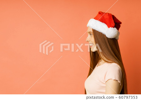Beautiful caucasian female model wearing santa hat Beautiful caucasian female model wearing santa hat 60797353