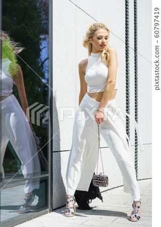 Woman wearing crop top and culottes Woman wearing crop top and culottes 60797419