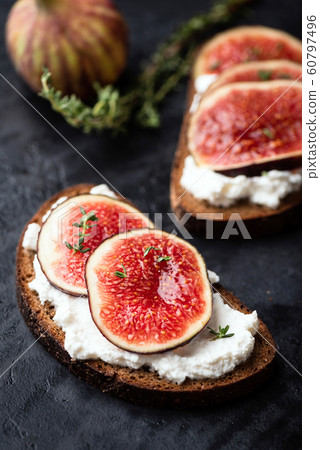 Tasty rye bread toast with cream cheese and figs 60797496
