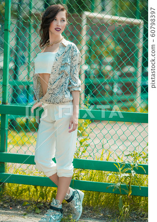 Outdoor fashion portrait of young goalkeepers girlfriend Outdoor fashion portrait of young goalkeepers girlfriend 60798397