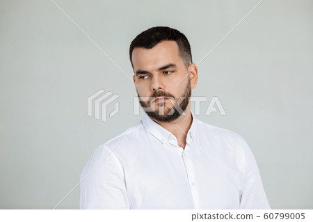 portrait of sad bearded man in white shirt 60799005