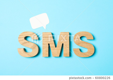 Word SMS lined with wooden letters on color Word SMS lined with wooden letters on color 60800226