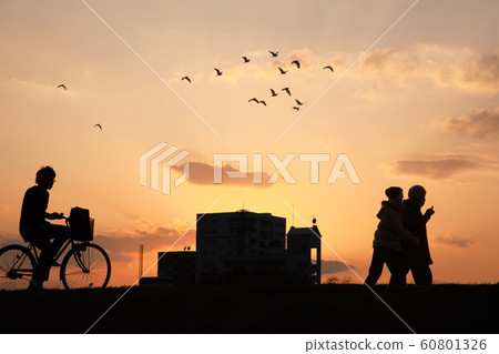 Return road at dusk. A bright red sunset sky with students and lovers. Silhouette image Hiroshima Return road at dusk. A bright red sunset sky with students and lovers. Silhouette image Hiroshima 60801326