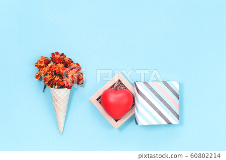 Orange autumn flowers in waffle cone with heart in 60802214